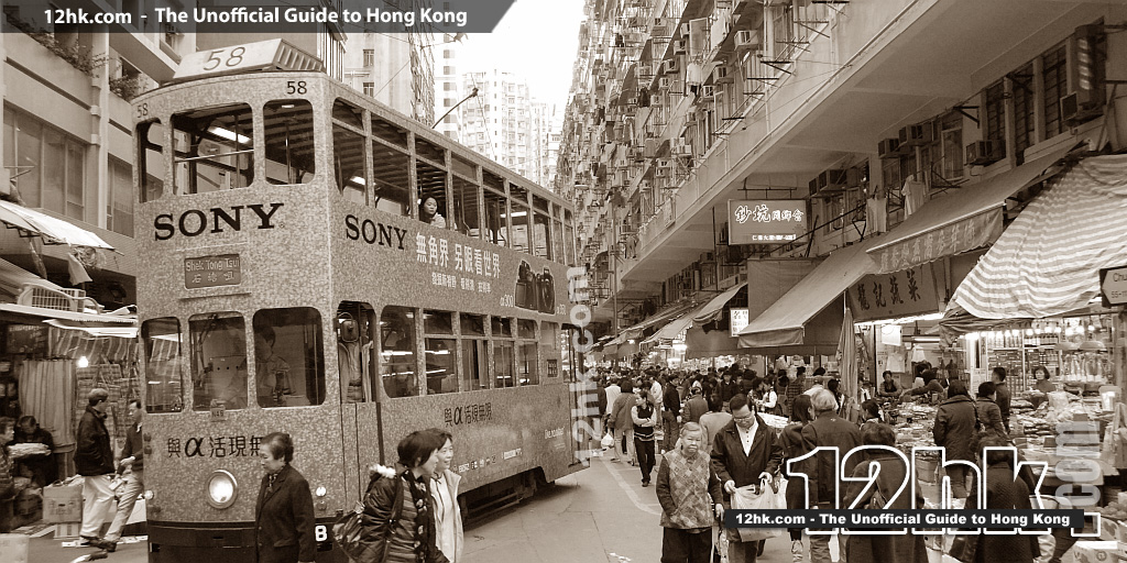 tram passing through Chun Yeung Street lined with butcher shops and 